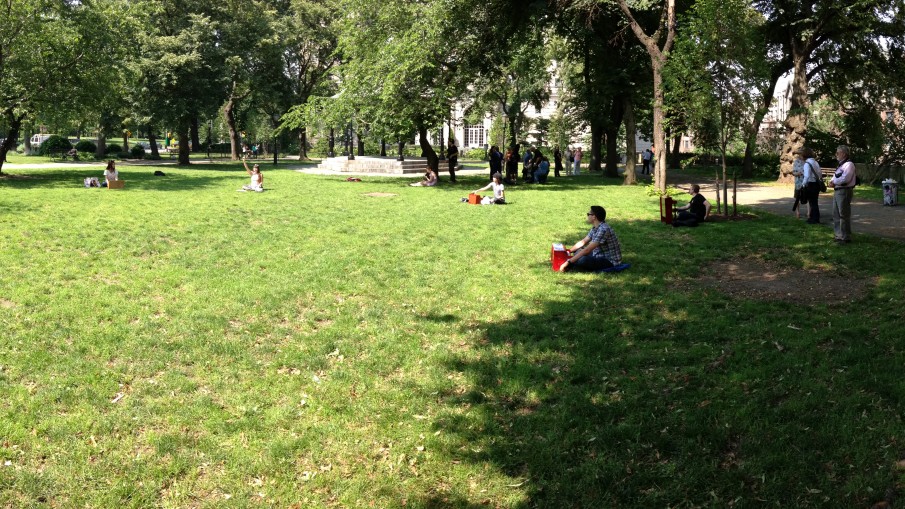 A group of toy pianists sit on the lawn at Sakura Park to perform Alexa Dexa's composition "Spottings on Safari" for Make Music NY.