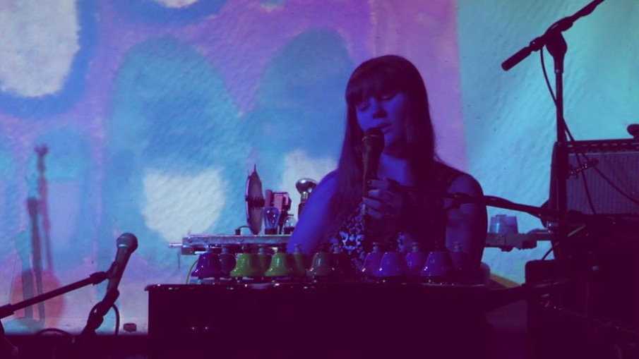 Alexa Dexa plays her toy instrument collection with projections of her watercolor paintings at the UnCaged Toy Piano Festival.